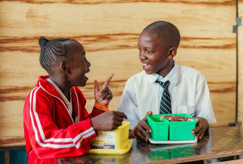 Students eating lunch at a primary school in Nairobi county, Kenya. Credit: Food4Education.