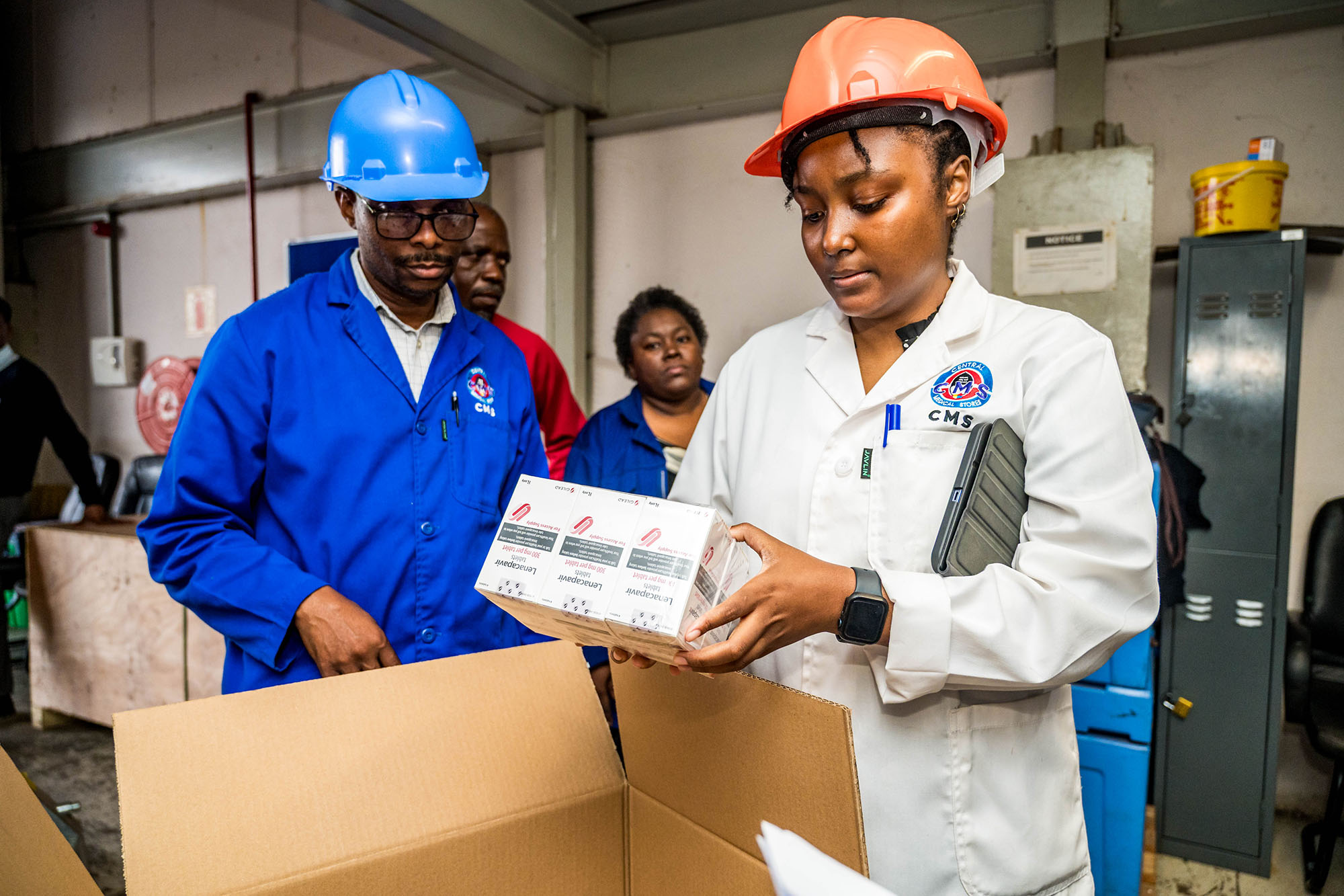 Two warehouse workers inspect a delivery.