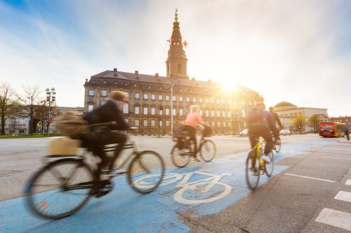 A group of cyclists commuting on bicycles in Copenhagen, Denmark. Credit: william87/ istock